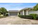 Charming home showcasing a well-maintained exterior, attached garage and mature landscaping at 15426 Sw 14Th Avenue Rd, Ocala, FL 34473