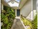 Inviting front entrance with lush landscaping leading to a stylish front door at 15426 Sw 14Th Avenue Rd, Ocala, FL 34473