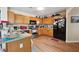 Functional kitchen with light wood cabinets, stainless steel appliances, and laminate flooring at 15426 Sw 14Th Avenue Rd, Ocala, FL 34473