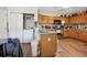 Functional kitchen with wood cabinets, modern appliances, and closet laundry at 15426 Sw 14Th Avenue Rd, Ocala, FL 34473