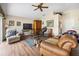 Bright living room featuring a ceiling fan, vaulted ceiling, and wood-look floors at 15426 Sw 14Th Avenue Rd, Ocala, FL 34473