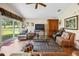 Bright living room featuring a ceiling fan, sliding glass doors and wood-look floors at 15426 Sw 14Th Avenue Rd, Ocala, FL 34473