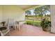 Screened patio with chairs, table, and potted plant overlooking the pristine golf course at 15426 Sw 14Th Avenue Rd, Ocala, FL 34473