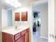 Bathroom with a vanity, a framed mirror, and a doorway view leading into another room at 17901 Sw 25Th Avenue Rd, Ocala, FL 34473