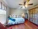 Bedroom featuring a daybed with striped pillows, complemented by a rustic cabinet and a window at 17901 Sw 25Th Avenue Rd, Ocala, FL 34473
