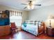 Cozy bedroom with a twin daybed, a window with striped valance, and a ceiling fan for comfort at 17901 Sw 25Th Avenue Rd, Ocala, FL 34473