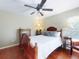 Comfortable bedroom with wooden furniture, including a detailed bed frame, dresser, and side tables at 17901 Sw 25Th Avenue Rd, Ocala, FL 34473