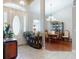 Elegant foyer leading to a dining area, featuring tile flooring and stylish decor that enhances the home's aesthetic at 17901 Sw 25Th Avenue Rd, Ocala, FL 34473