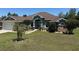 Charming one-story home featuring a manicured lawn and stone accents, creating an inviting curb appeal at 17901 Sw 25Th Avenue Rd, Ocala, FL 34473