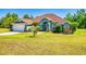 Charming blue single-story home with a spacious lawn, stone accents, and an attached two car garage at 17901 Sw 25Th Avenue Rd, Ocala, FL 34473