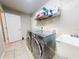 Functional laundry room featuring modern washer and dryer units, a utility sink, and ample storage space at 17901 Sw 25Th Avenue Rd, Ocala, FL 34473