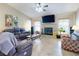 Cozy living room featuring a fireplace, large windows, and comfortable seating at 17901 Sw 25Th Avenue Rd, Ocala, FL 34473