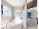Close-up of tub and shower in a bright main bathroom featuring tile floors and ample natural light at 17901 Sw 25Th Avenue Rd, Ocala, FL 34473