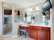 Bright main bathroom featuring tile floors, double vanity, walk-in shower, and vanity area at 17901 Sw 25Th Avenue Rd, Ocala, FL 34473