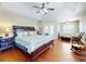 Spacious main bedroom with hardwood floors, tray ceilings, sitting area and access to a private balcony at 17901 Sw 25Th Avenue Rd, Ocala, FL 34473