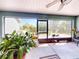 Relaxing screened-in patio providing a view of the outdoors, potted plants, and peaceful nature views at 17901 Sw 25Th Avenue Rd, Ocala, FL 34473