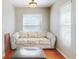 Cozy sitting room with hardwood floors, natural light from the windows and a comfortable neutral sofa at 17901 Sw 25Th Avenue Rd, Ocala, FL 34473