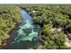 Scenic aerial view featuring the winding river, surrounding trees, and nearby homes at 21939 Sw 85Th Loop, Dunnellon, FL 34431