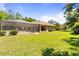 Lush backyard featuring a screened-in pool area, perfect for outdoor entertainment and relaxation at 21939 Sw 85Th Loop, Dunnellon, FL 34431