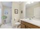 Bright bathroom with a large mirror, a wooden vanity, and tiled floors at 21939 Sw 85Th Loop, Dunnellon, FL 34431