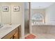 An elegant bathroom with a soaking tub, separate shower, and ample natural light at 21939 Sw 85Th Loop, Dunnellon, FL 34431
