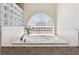 A luxurious white bathtub is accented by glass block window letting in natural light at 21939 Sw 85Th Loop, Dunnellon, FL 34431