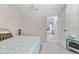Well lit bedroom featuring a bed and a dresser, next to the open door to the sitting room at 21939 Sw 85Th Loop, Dunnellon, FL 34431