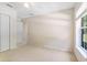 Spacious bedroom with neutral walls, carpeted floors and a large window at 21939 Sw 85Th Loop, Dunnellon, FL 34431