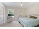 Comfortable bedroom with a large bed, white furnishings and plenty of natural light at 21939 Sw 85Th Loop, Dunnellon, FL 34431