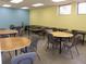An activity room in the community center with tables, chairs, and neutral decor at 21939 Sw 85Th Loop, Dunnellon, FL 34431