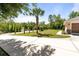 The home sits back from the street with palm trees in the yard and long driveway and 3 car garage at 21939 Sw 85Th Loop, Dunnellon, FL 34431