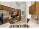 Spacious kitchen with stainless steel appliances and wood cabinets, with the laundry room in view at 21939 Sw 85Th Loop, Dunnellon, FL 34431