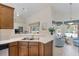 Kitchen area showcasing counters, wooden cabinets, and a breakfast bar area leading to living spaces at 21939 Sw 85Th Loop, Dunnellon, FL 34431