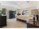 A bright main bedroom with a fireplace, large windows and a door to the lanai at 21939 Sw 85Th Loop, Dunnellon, FL 34431