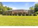 Wide shot of screened in pool and patio area, with lush green lawn at 21939 Sw 85Th Loop, Dunnellon, FL 34431