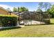 A screened pool area features comfortable lounge chairs and a refreshing swimming pool surrounded by lush greenery at 21939 Sw 85Th Loop, Dunnellon, FL 34431