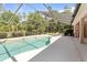 Pool with screened enclosure, a sunbathing deck and manicured landscaping at 21939 Sw 85Th Loop, Dunnellon, FL 34431