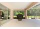 Screened porch with barbecue grill, offering an outdoor cooking area at 21939 Sw 85Th Loop, Dunnellon, FL 34431