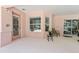 Covered outdoor patio featuring patio furniture and views of screened in pool at 21939 Sw 85Th Loop, Dunnellon, FL 34431