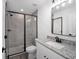 Modern bathroom featuring gray tile shower with black trim and granite vanity top at 24354 Nw Water Oak Ave, Dunnellon, FL 34431