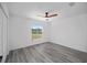 Bright bedroom features a ceiling fan, gray floors and window for natural light at 24354 Nw Water Oak Ave, Dunnellon, FL 34431