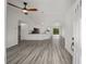 Open-concept living room showcasing durable floors and seamless transition to kitchen with breakfast bar at 24354 Nw Water Oak Ave, Dunnellon, FL 34431