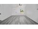 Open living area showcases wood-style flooring, a bright entryway, and natural light at 24354 Nw Water Oak Ave, Dunnellon, FL 34431