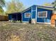 A blue home with a spacious backyard, air conditioner, and partial wooden fence at 25292 Ne 132Nd Ln, Fort Mc Coy, FL 32134