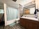 Cozy bathroom with floral shower curtain, vanity with mirror, and wood-look flooring at 25292 Ne 132Nd Ln, Fort Mc Coy, FL 32134