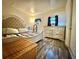 This bedroom features a large bed, matching dressers, and wood-look floors at 25292 Ne 132Nd Ln, Fort Mc Coy, FL 32134
