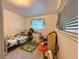 bedroom with a dinosaur-themed bed, rug, and toys at 25292 Ne 132Nd Ln, Fort Mc Coy, FL 32134