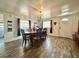 Well-lit dining room featuring wood floors, a chandelier, and a dining table with seating for six at 25292 Ne 132Nd Ln, Fort Mc Coy, FL 32134