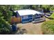 An exterior shot of a charming home with a metal roof, wooden deck, and blue siding at 25292 Ne 132Nd Ln, Fort Mc Coy, FL 32134