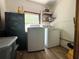 Close-up of laundry room with washer, dryer, safe, and storage shelves at 25292 Ne 132Nd Ln, Fort Mc Coy, FL 32134